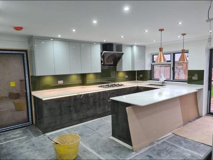 New open-plan kitchen with island, quartz worktops and copper pendant lights
