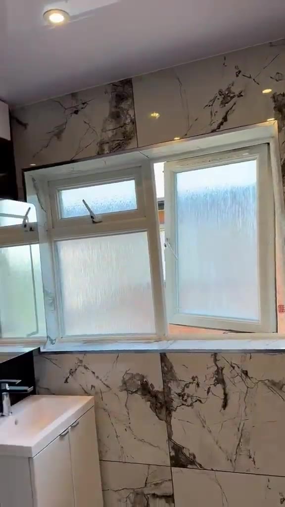 Bathroom with marble-effect tiles and glass shower
